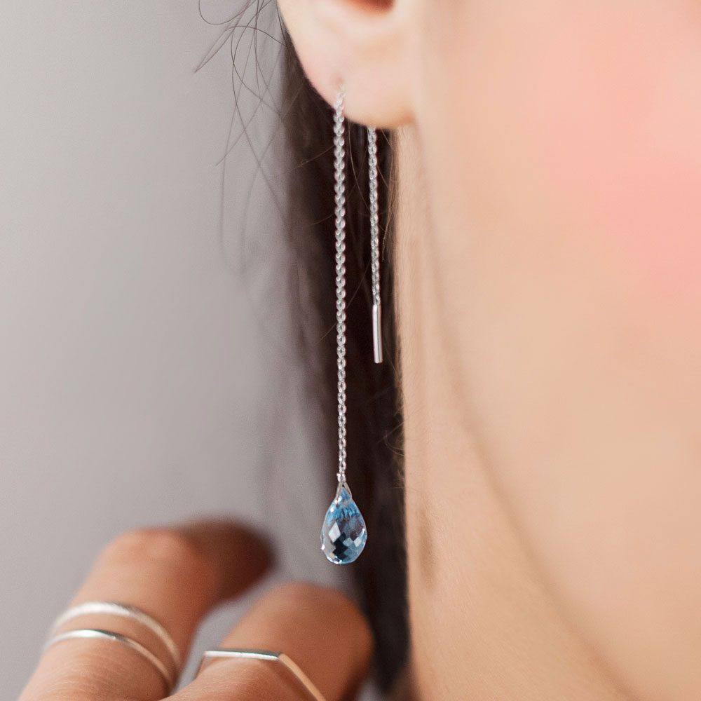 Tiny Blue Topaz Threader Earrings in White Gold Worn By A Woman