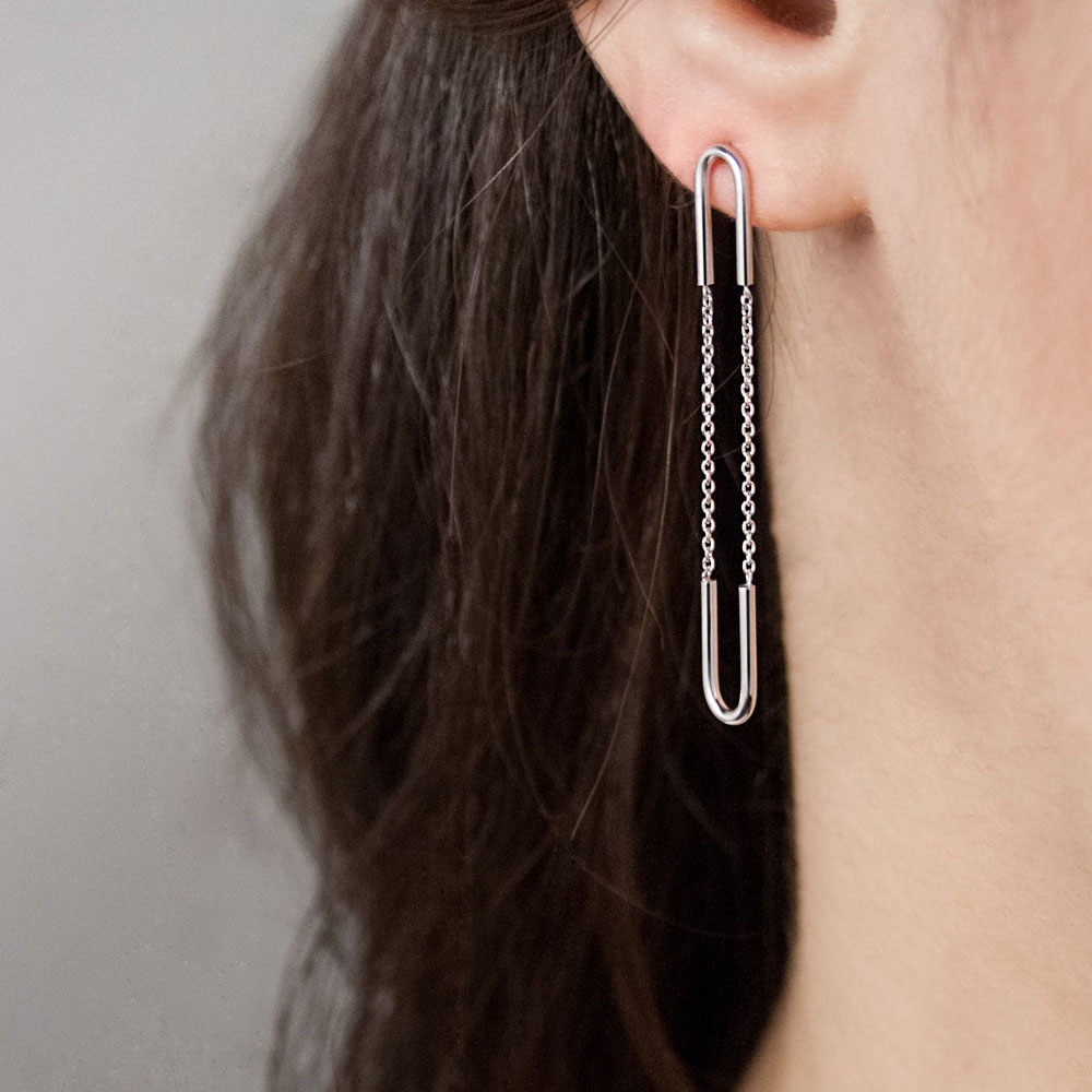 Long White Gold Dangling Earrings with Chain Worn By A Woman