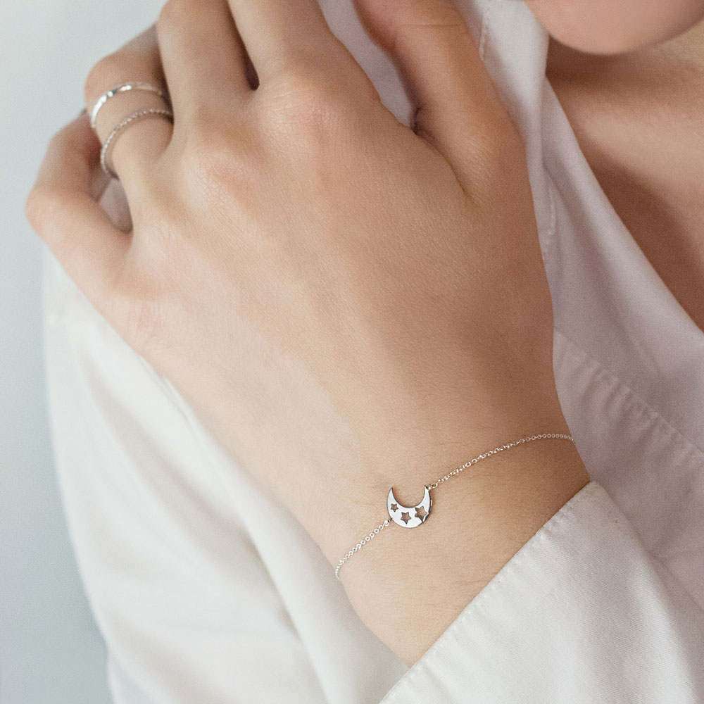 Dainty Half Moon and Stars, A Unique White Gold Bracelet Worn By A Woman