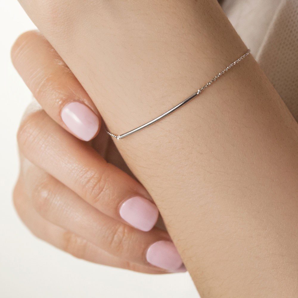 Simple Thin Bar Bracelet in White Gold Worn By A Woman