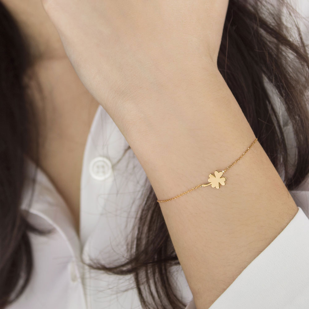 Lucky Bracelet with a Yellow Gold 4-Leaf Clover Charm Worn By A Woman