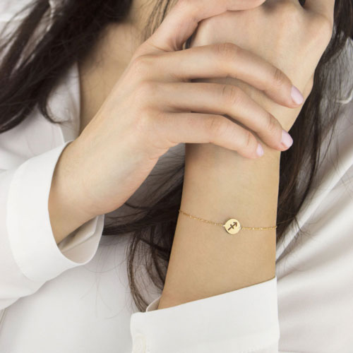 Zodiac Sign Bracelet in Yellow Gold Worn By A Woman