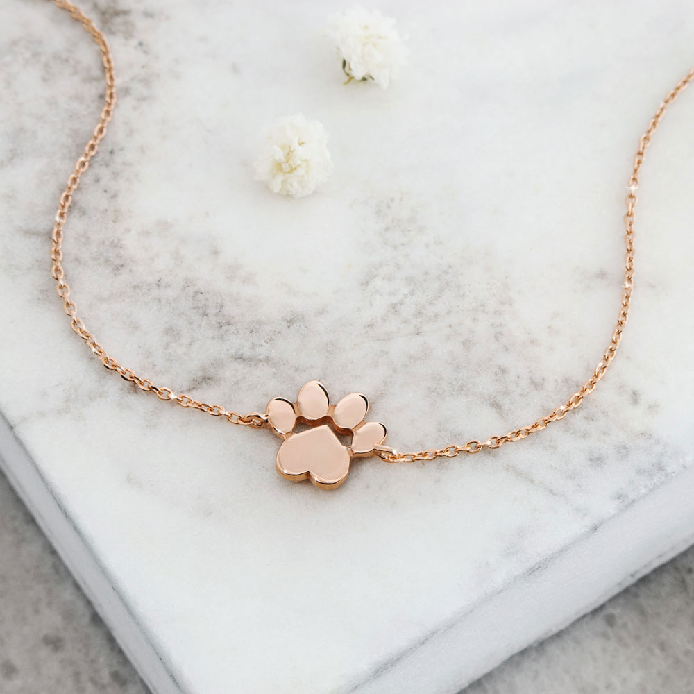 a paw print charm in rose gold