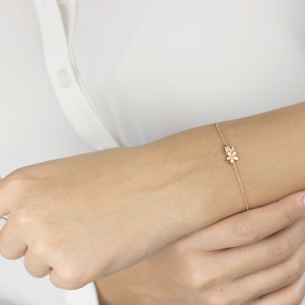 Rose Gold Bracelet with a Flower and Leaf Charm Worn By A Woman