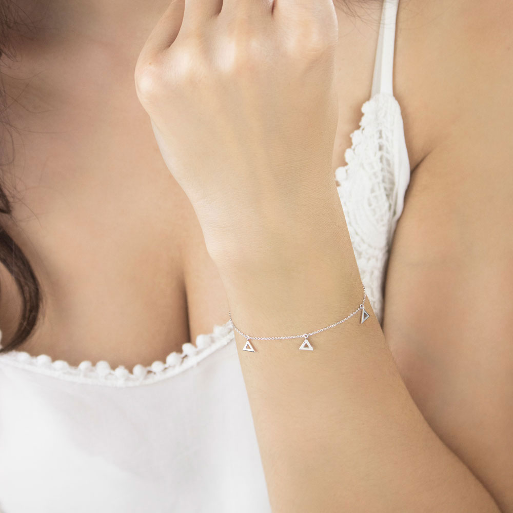 White Gold Dangling Triangle Charms Bracelet Worn By A Woman