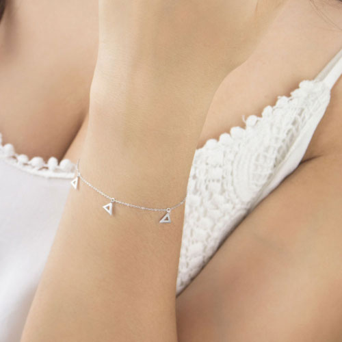 White Gold Dangling Triangle Charms Bracelet Worn By A Woman