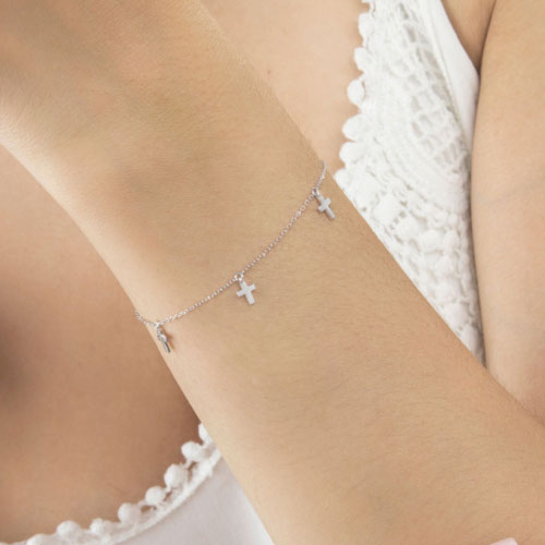 White Gold Dangling Bracelet with Tiny Cross Charms Worn By A Woman
