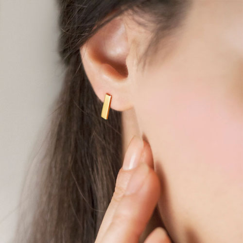 Simple Gold Bar Stud Earrings in Solid Gold Worn By A Woman
