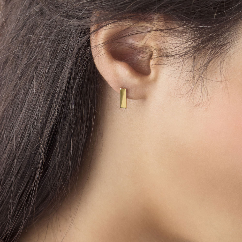 Simple Yellow Gold Bar Stud Earrings in Solid Gold Worn By A Woman