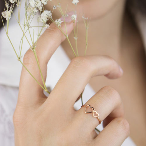 Double Heart Ring made of Rose Gold Worn By A Woman
