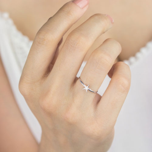Dainty Starfish Ring made of White Gold Worn By A Woman
