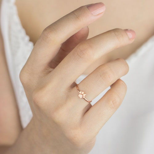 a rose gold ring with a tiny paw print Worn By A Woman