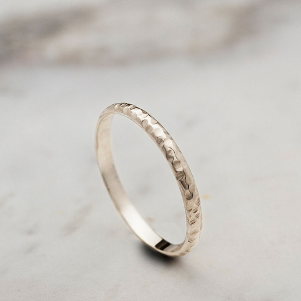 Thin Wedding Band with a Hammered Finish in Yellow Gold