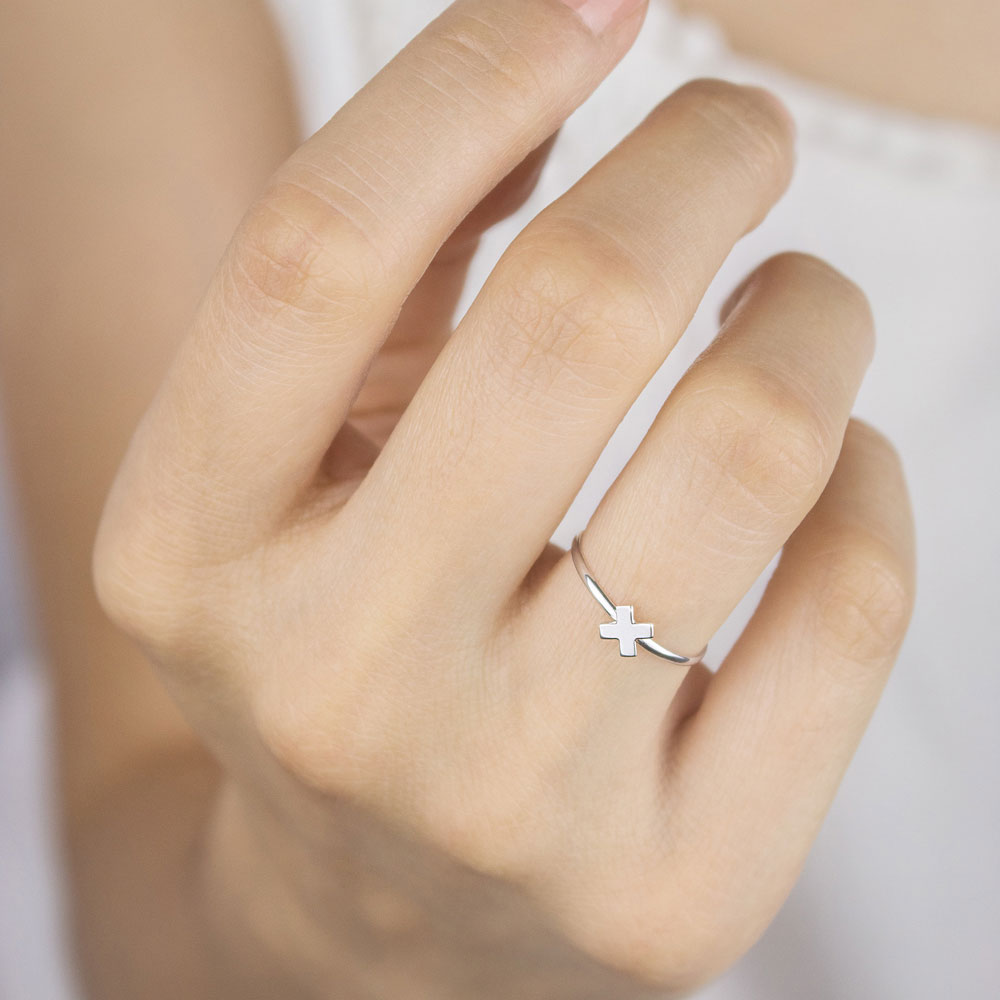 Dainty X Ring made of White Gold Worn By A Woman