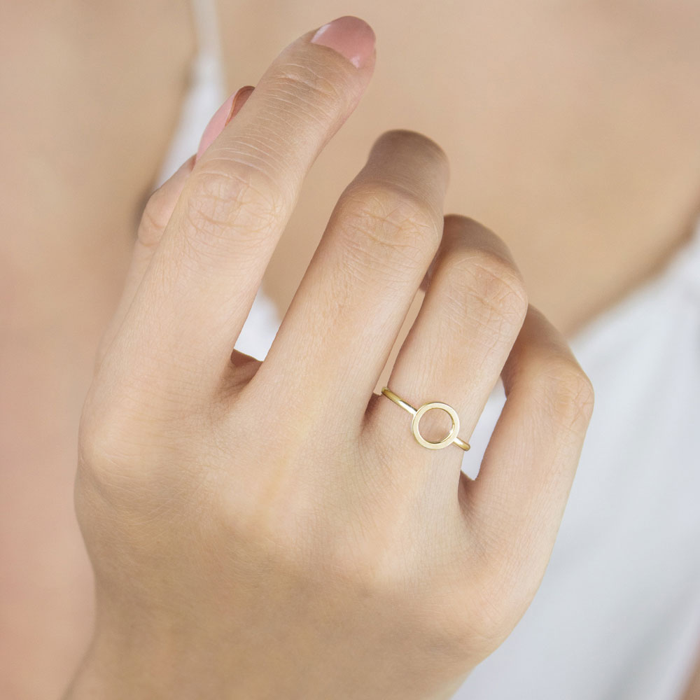 Yellow Gold Band Ring with a Small Circle Worn By A Woman
