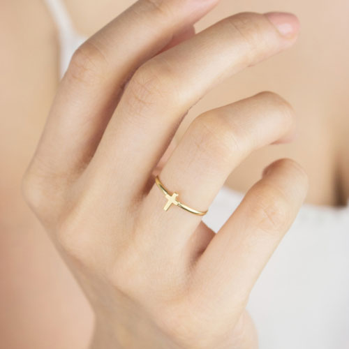 Small Cross Ring in Yellow Gold Worn By A Woman