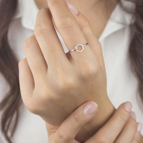 White Gold Band Ring with a Small Hexagon Worn By A Woman