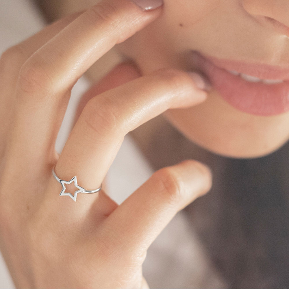 Dainty White Gold Ring with a Shiny Star Worn By A Woman