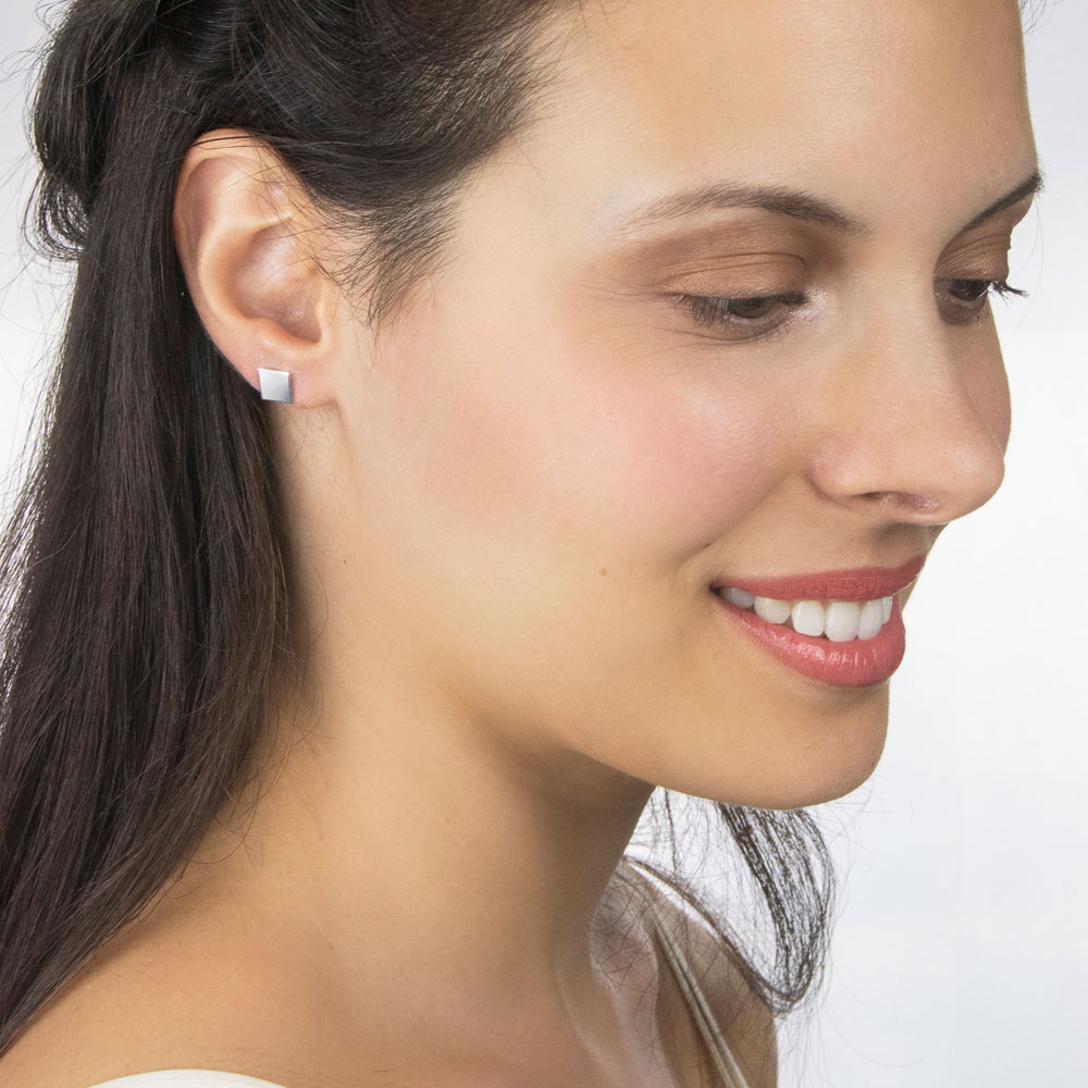 Simple White Gold Square Stud Earrings Worn By A Woman