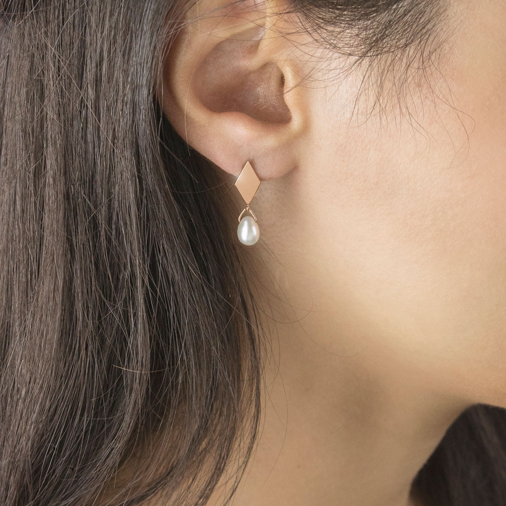 Rhombus Rose Gold Studs with a Tiny Dangling White Pearl Worn By A Woman