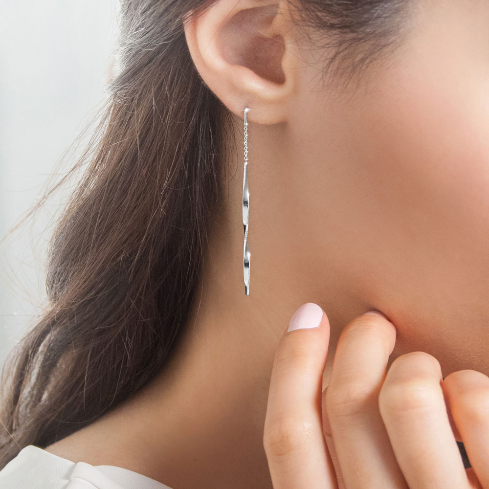 Long White Gold Dangling Earrings with a Twisted Bar Worn By A Woman
