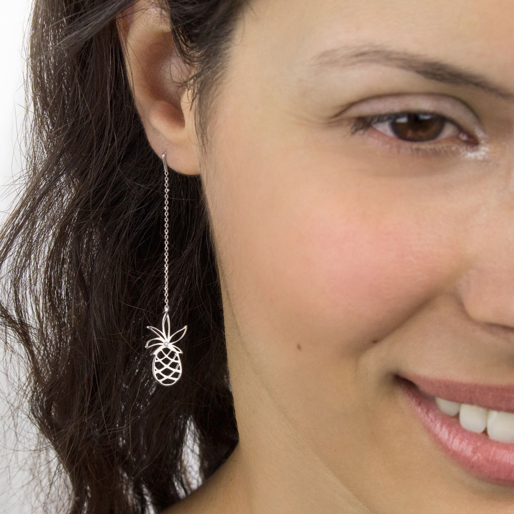 Long White Gold Earrings with a Pineapple and a Tiny Diamond Worn By A Woman