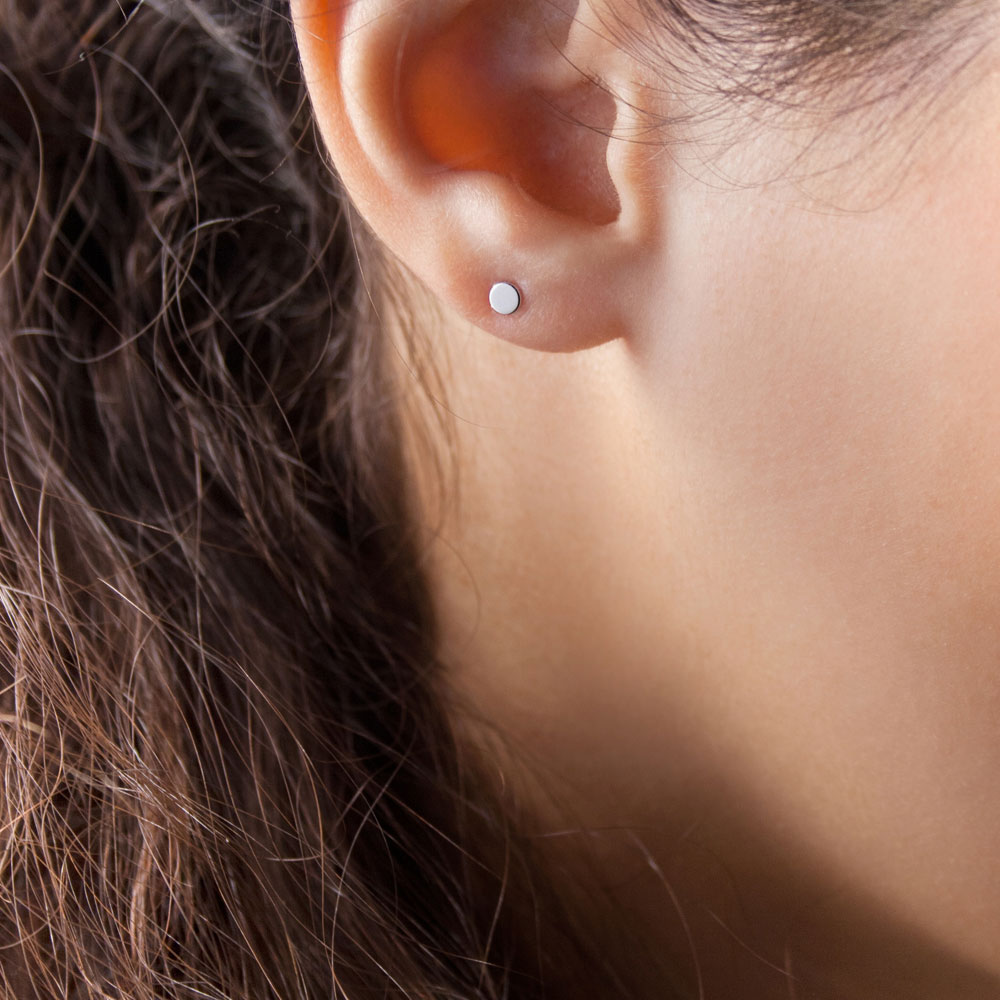 Tiny Dot Stud Earrings in White Gold Worn By A Woman