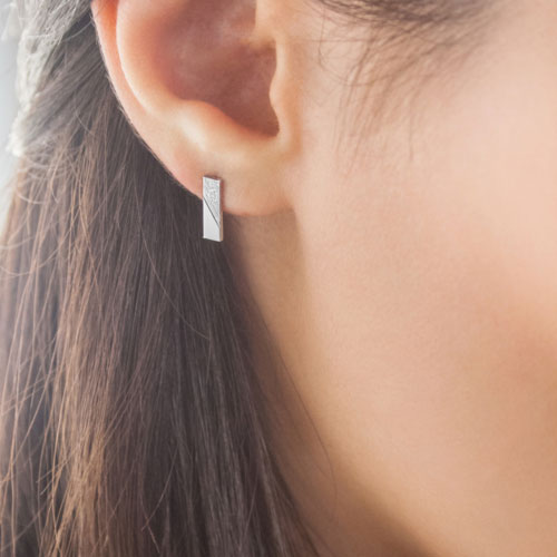Simple White Gold Bar Stud Earrings with a Contrast Worn By A Woman