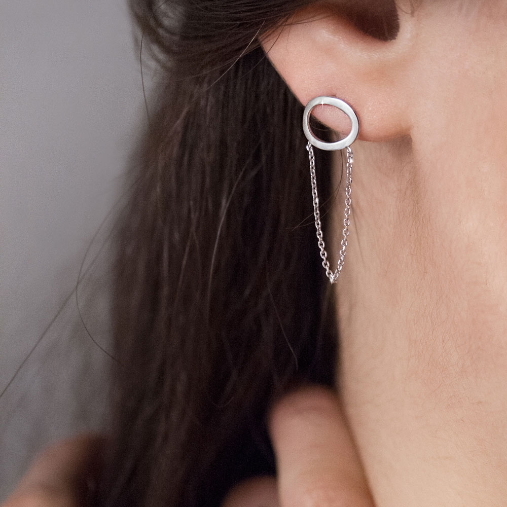 Long White Gold Chain Earrings with a Dainty Oval Worn By A Woman