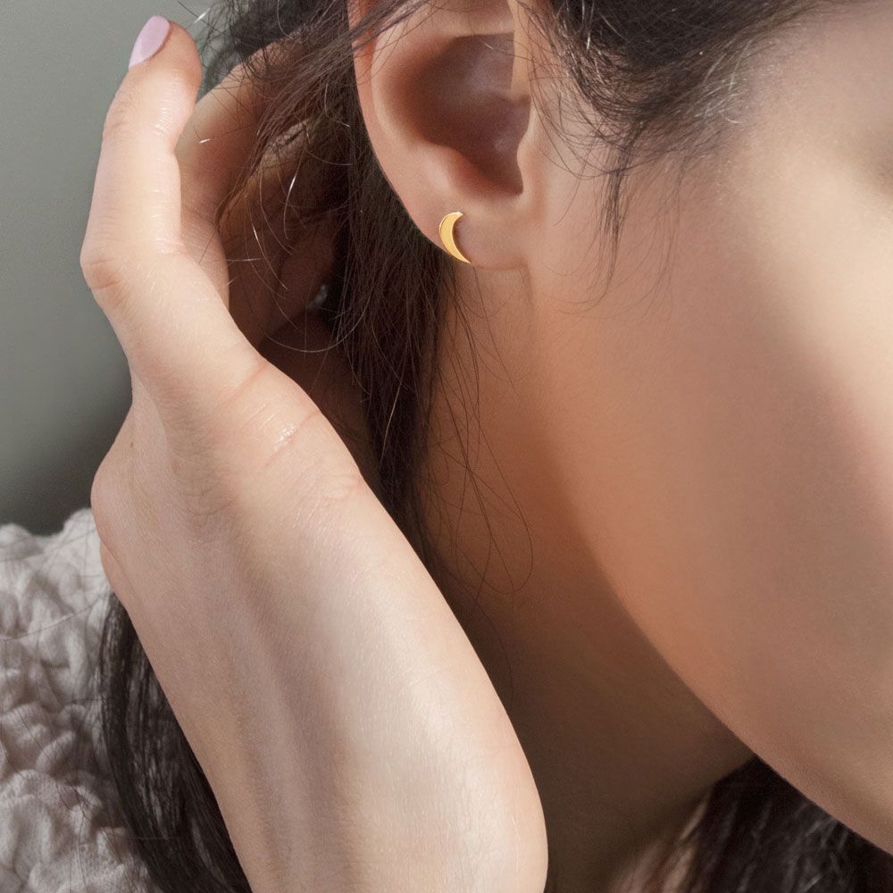 Small Crescent Moon Stud Earrings in Yellow Gold Worn By A Woman