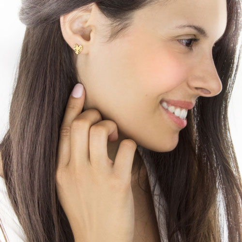 Tropical Monstera Leaf Studs In Yellow Gold Worn By A Woman