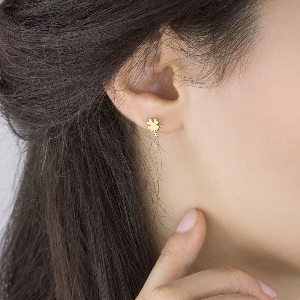 Four-Leaf Clover Studs in Yellow Gold Worn By A Woman