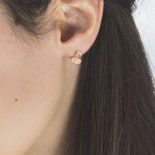 Sweet Cherry Stud Earrings made of Rose Gold Worn By A Woman