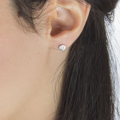 Dainty Seashell Stud Earrings in White Gold Worn By A Woman