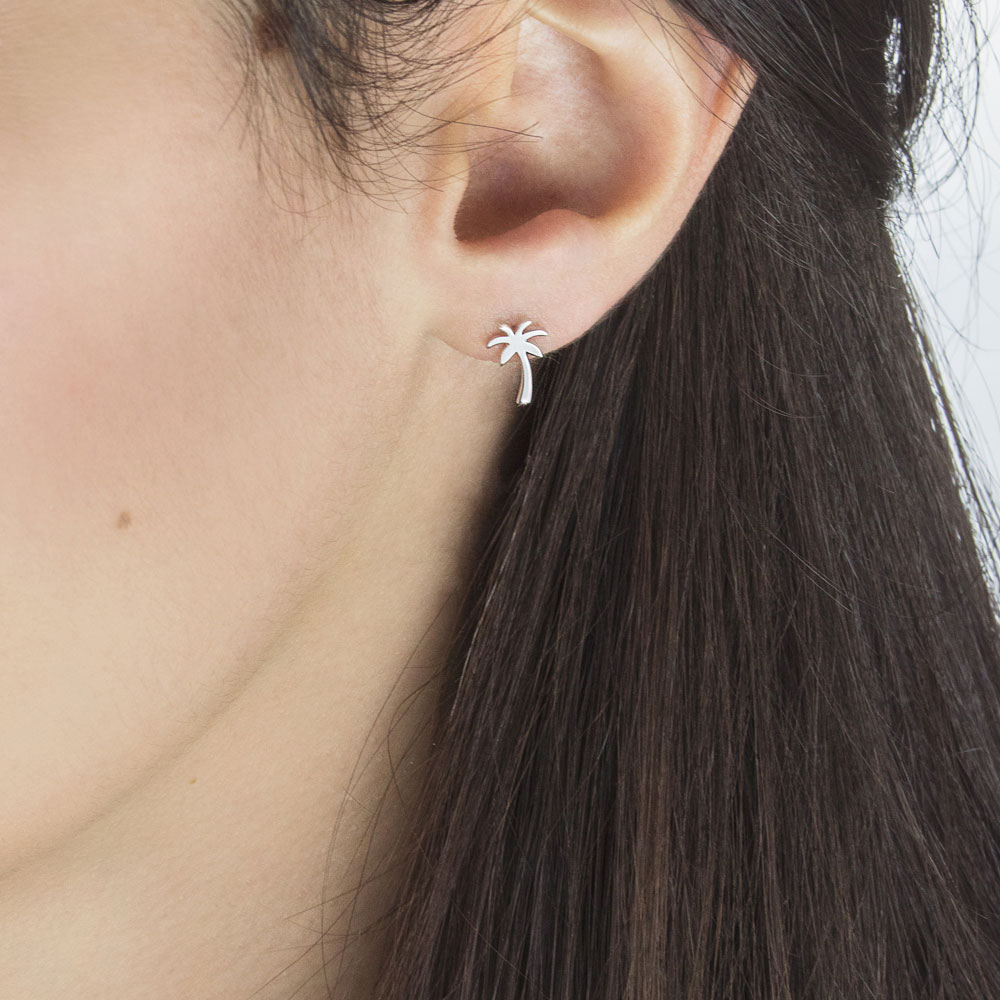 Small Palm Tree White Gold Stud Earrings Worn By A Woman