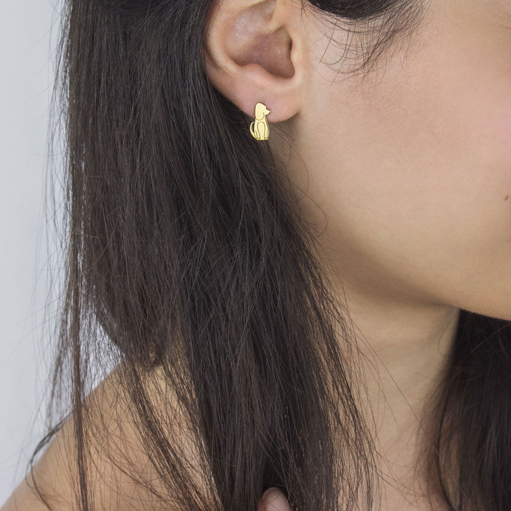Cute Dog Studs made of Yellow Gold Worn By A Woman