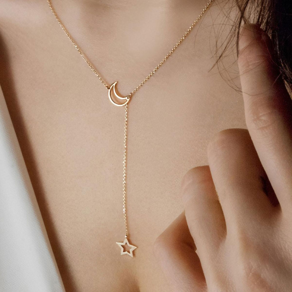 Lariat style necklace with a moon and a star in rose gold