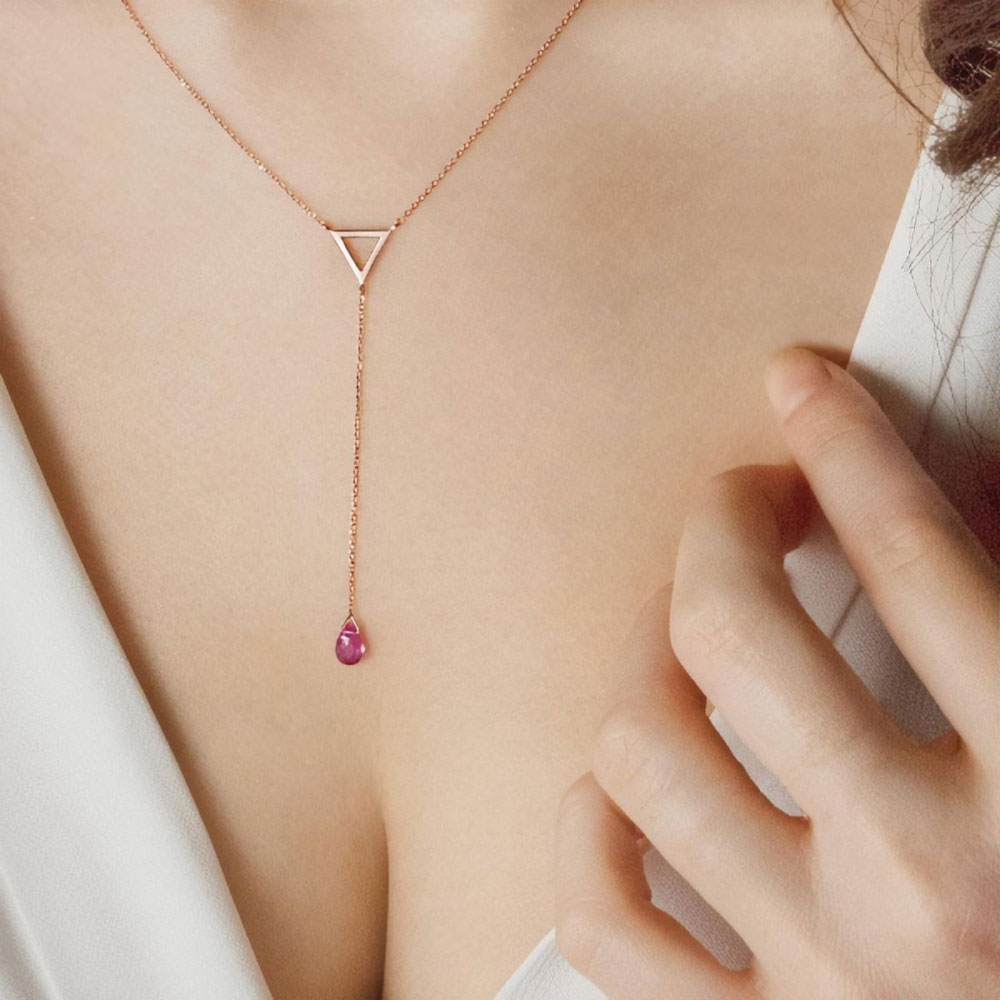 Rose Gold Y Necklace with a Triangle and a Tiny Tourmaline Worn By A Woman
