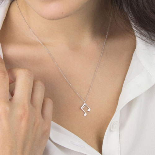 Music Note Pendant Necklace in White Gold Worn By A Woman