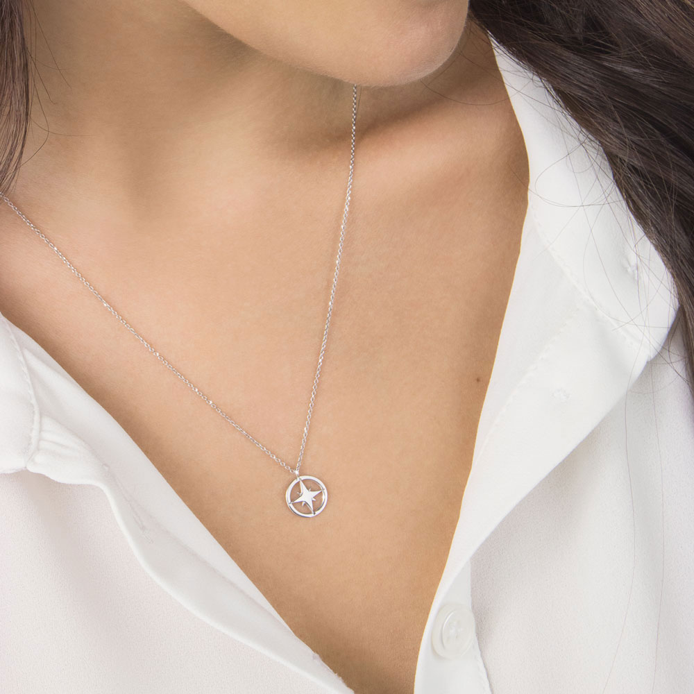 Dainty Compass Pendant Necklace made of White Gold Worn By A Woman