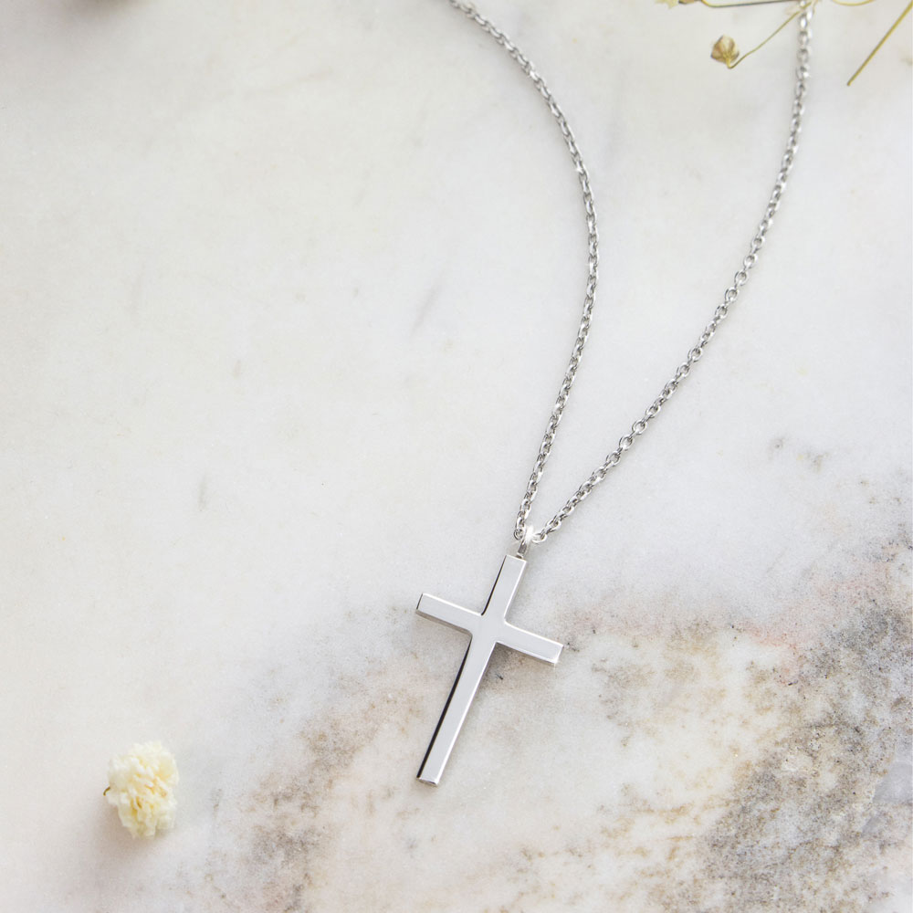 a small thin cross pendant necklace in white gold