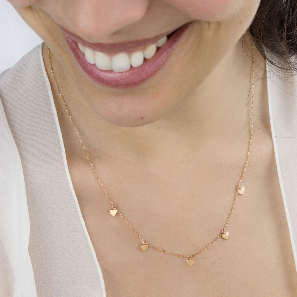 Tiny Multiple Hearts Dangling, Rose Gold Necklace Worn By A Woman