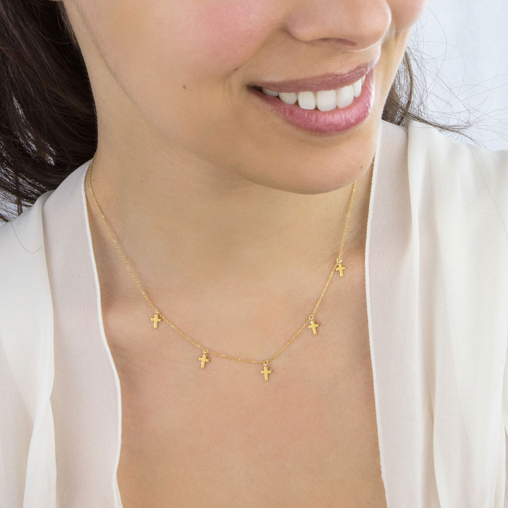 Tiny Dangling Cross Charms, Necklace in Yellow Gold Worn By A Woman