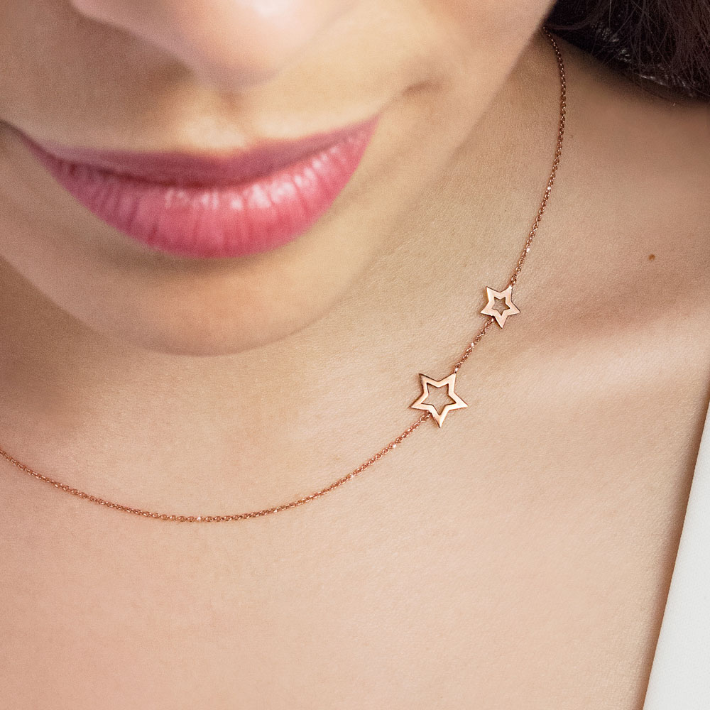 Two Side Stars Necklace made of Rose Gold Worn By A Woman