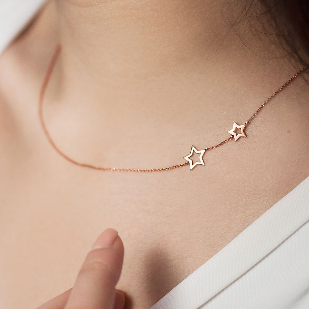 Two Side Stars Necklace made of Rose Gold Worn By A Woman