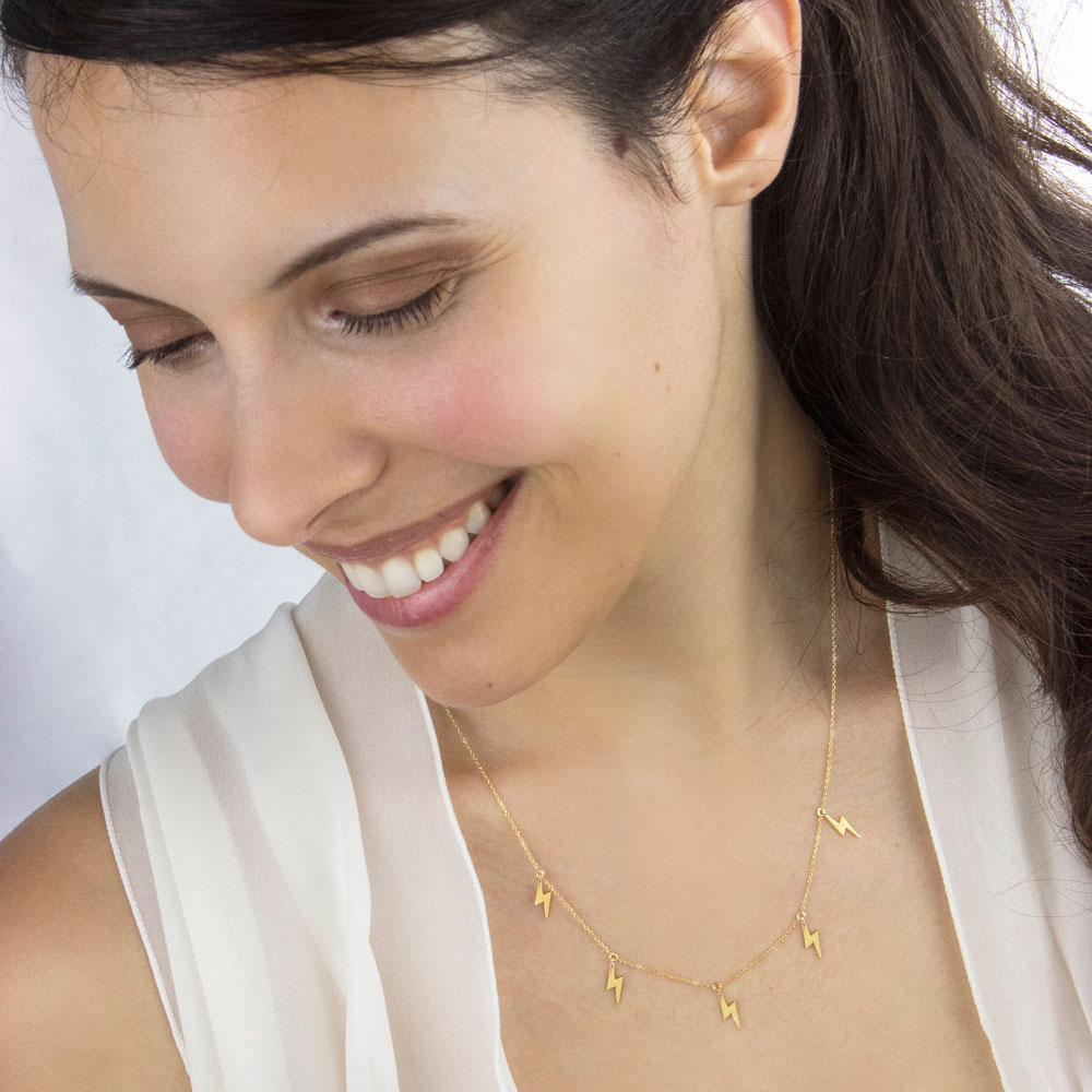 Dangling Lightning Bolt Charms, Necklace made of Yellow Gold Worn By A Woman