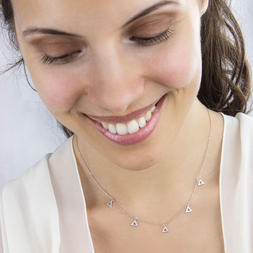 Tiny White Gold Triangle Charms in White Gold Dangling Necklace Worn By A Woman