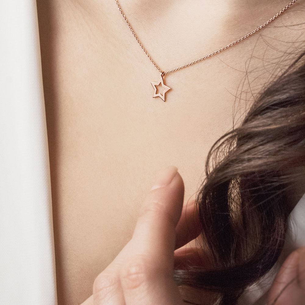 Rose Gold Star Pendant Necklace Worn By A Woman