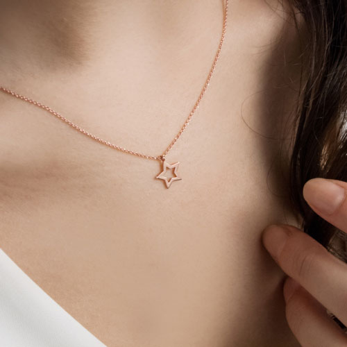 Rose Gold Star Pendant Necklace Worn By A Woman