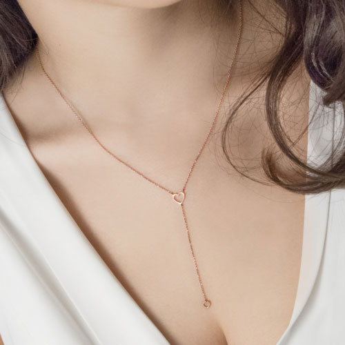 Rose Gold Y Necklace with Two Dainty Hearts Worn By A Woman